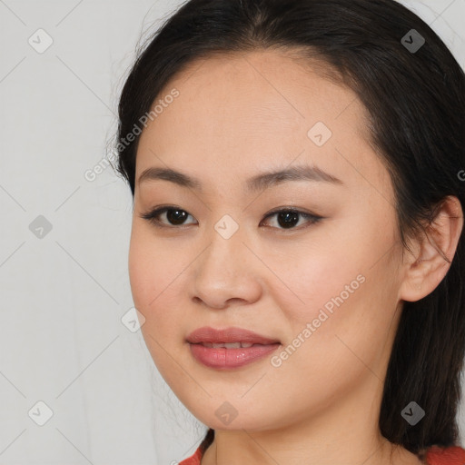 Joyful asian young-adult female with long  brown hair and brown eyes