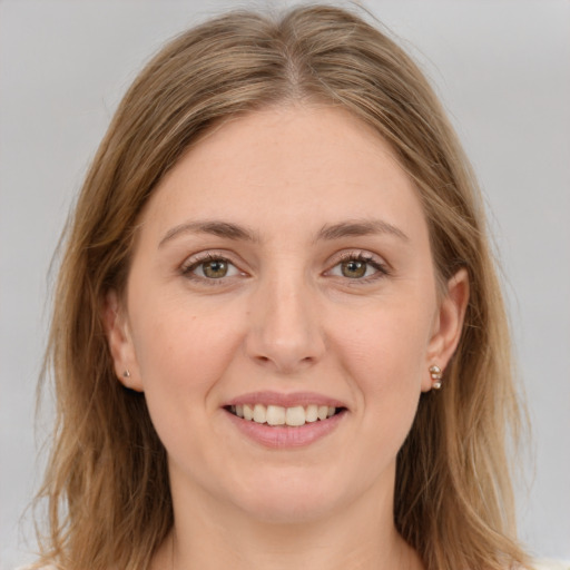 Joyful white young-adult female with long  brown hair and green eyes