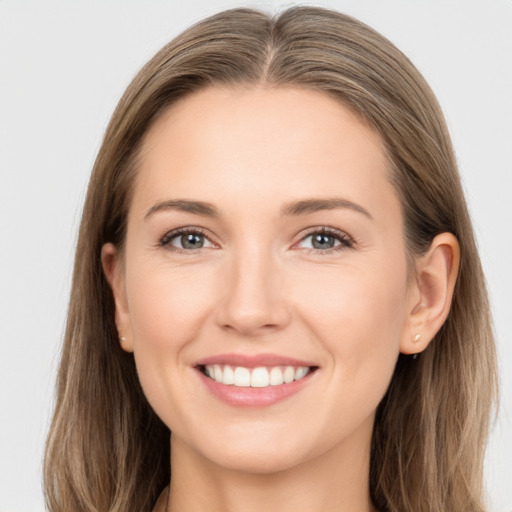 Joyful white young-adult female with long  brown hair and grey eyes