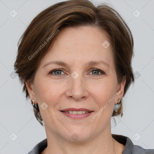 Joyful white adult female with medium  brown hair and grey eyes