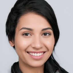 Joyful white young-adult female with long  black hair and brown eyes