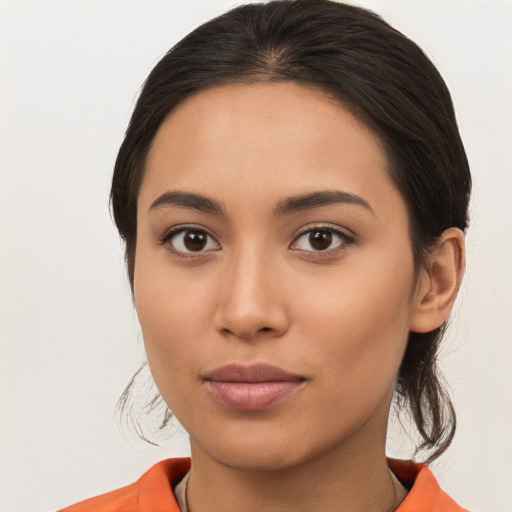 Joyful latino young-adult female with medium  brown hair and brown eyes