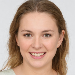 Joyful white young-adult female with medium  brown hair and green eyes