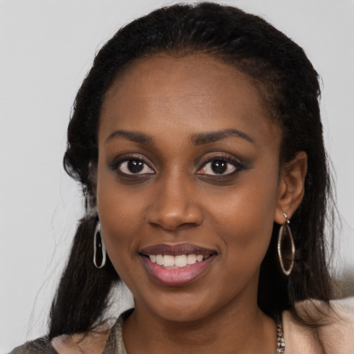 Joyful black young-adult female with medium  black hair and brown eyes