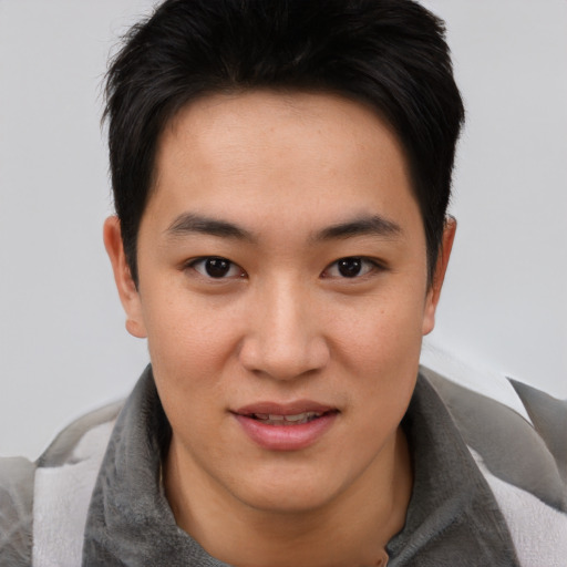 Joyful asian young-adult male with short  brown hair and brown eyes