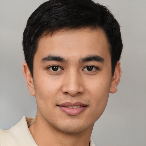 Joyful latino young-adult male with short  brown hair and brown eyes