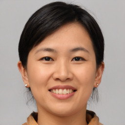 Joyful asian young-adult female with medium  brown hair and brown eyes