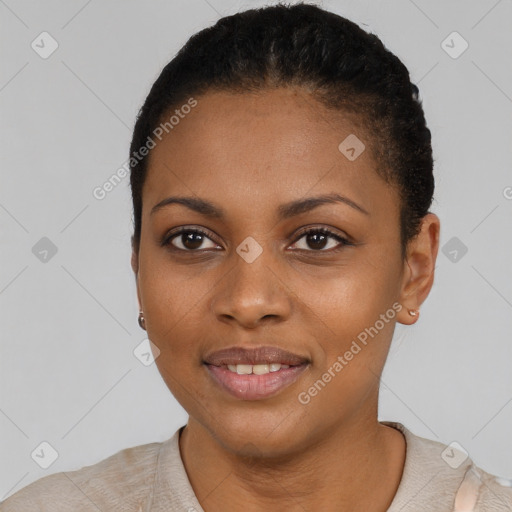 Joyful black young-adult female with short  black hair and brown eyes