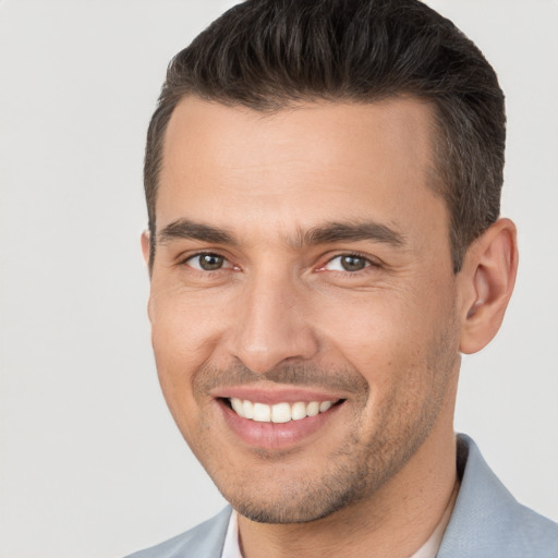 Joyful white young-adult male with short  brown hair and brown eyes