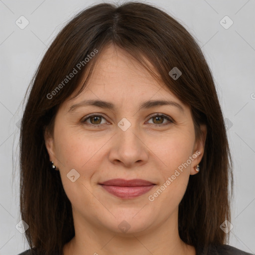 Joyful white adult female with long  brown hair and brown eyes