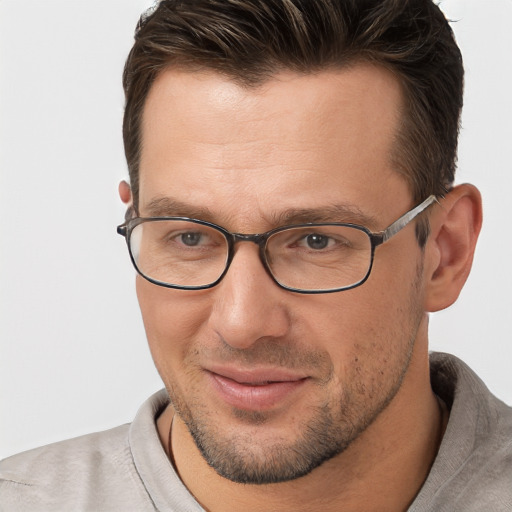 Joyful white adult male with short  brown hair and brown eyes