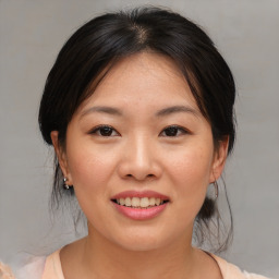 Joyful asian young-adult female with medium  brown hair and brown eyes