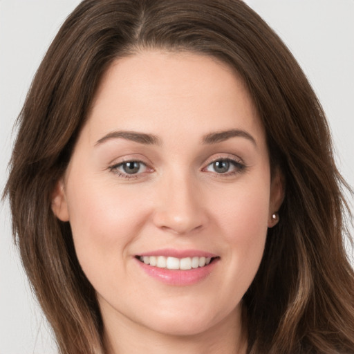 Joyful white young-adult female with long  brown hair and grey eyes