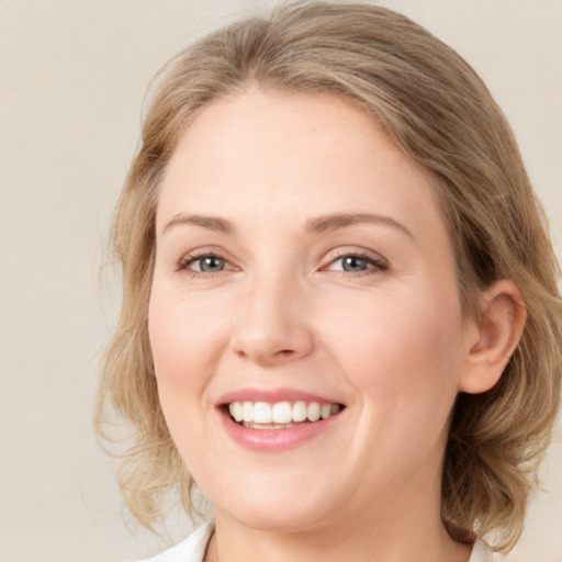 Joyful white young-adult female with medium  brown hair and green eyes