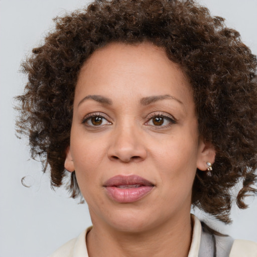 Joyful black adult female with medium  brown hair and brown eyes