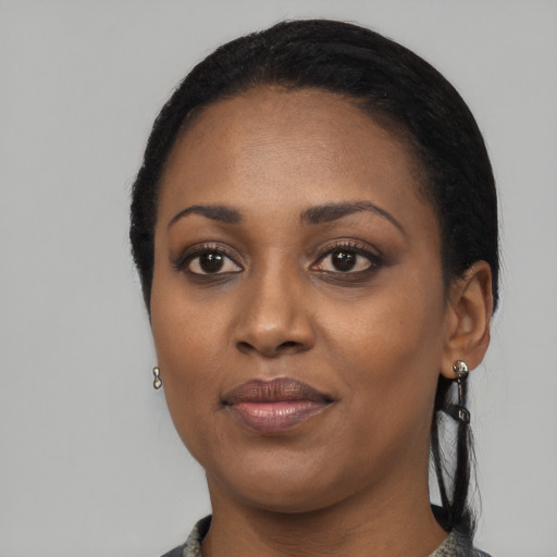 Joyful black young-adult female with medium  black hair and brown eyes