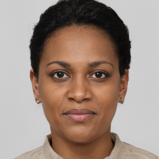Joyful black young-adult female with short  black hair and brown eyes