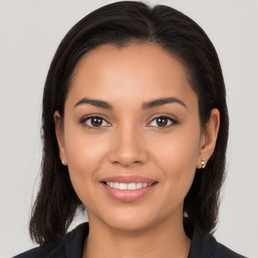 Joyful latino young-adult female with long  brown hair and brown eyes