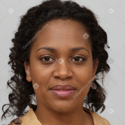 Joyful black adult female with medium  brown hair and brown eyes