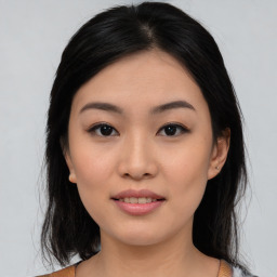 Joyful asian young-adult female with medium  black hair and brown eyes