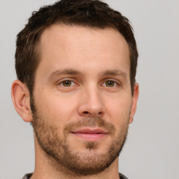 Joyful white young-adult male with short  brown hair and grey eyes