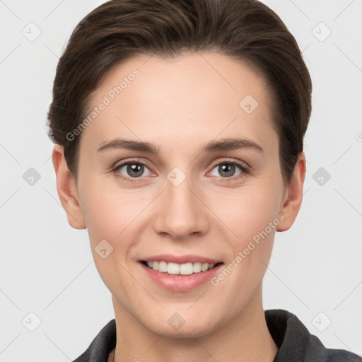 Joyful white young-adult female with short  brown hair and grey eyes