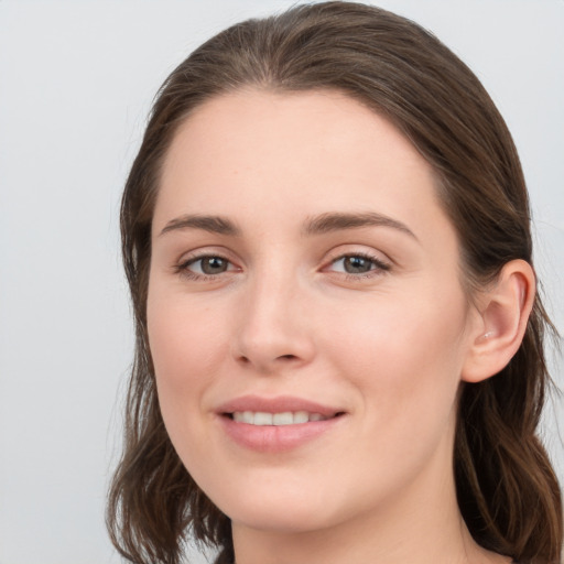 Joyful white young-adult female with long  brown hair and grey eyes