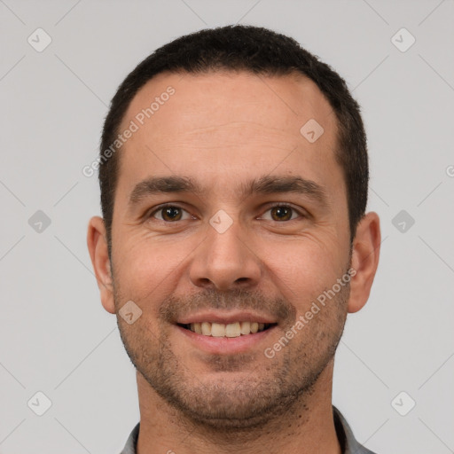 Joyful white young-adult male with short  brown hair and brown eyes