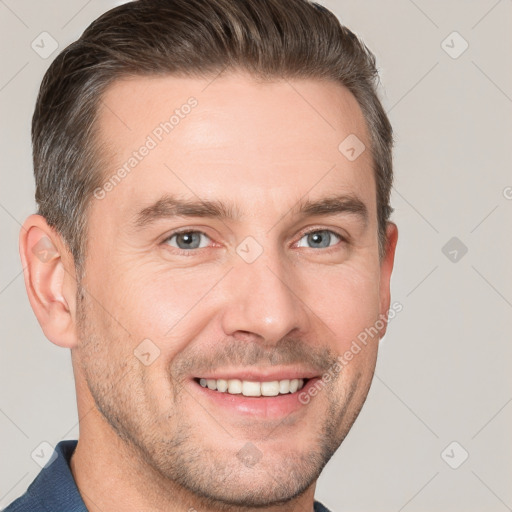 Joyful white adult male with short  brown hair and grey eyes