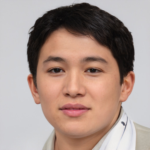 Joyful asian young-adult male with short  brown hair and brown eyes