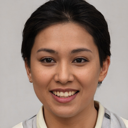 Joyful asian young-adult female with short  brown hair and brown eyes