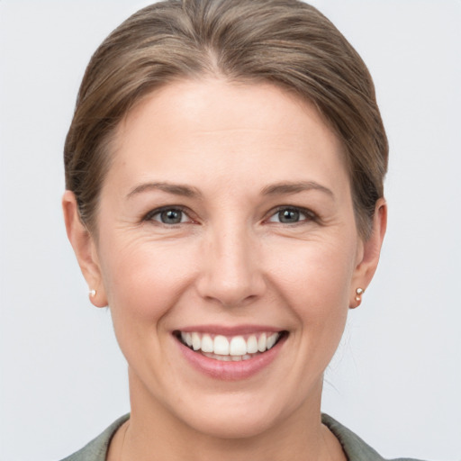 Joyful white adult female with short  brown hair and grey eyes