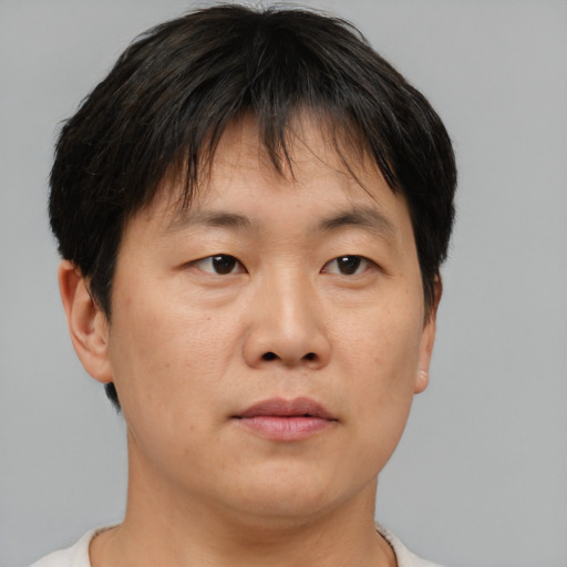Neutral asian adult male with short  brown hair and brown eyes