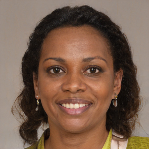 Joyful black young-adult female with medium  brown hair and brown eyes