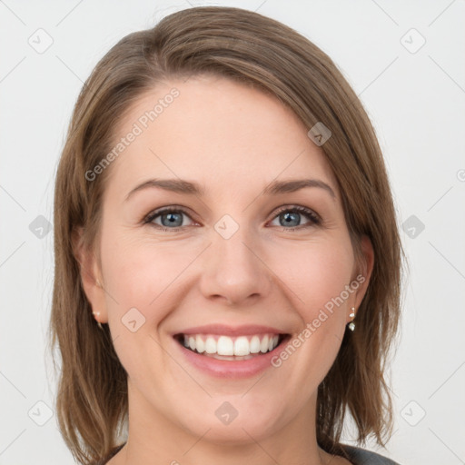 Joyful white young-adult female with medium  brown hair and grey eyes