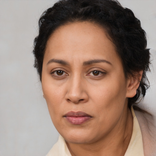 Joyful latino adult female with short  brown hair and brown eyes