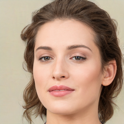 Joyful white young-adult female with medium  brown hair and green eyes