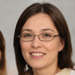 Joyful white adult female with medium  brown hair and brown eyes