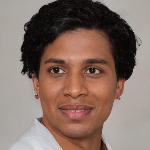 Joyful white young-adult male with short  black hair and brown eyes