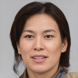 Joyful white adult female with medium  brown hair and brown eyes