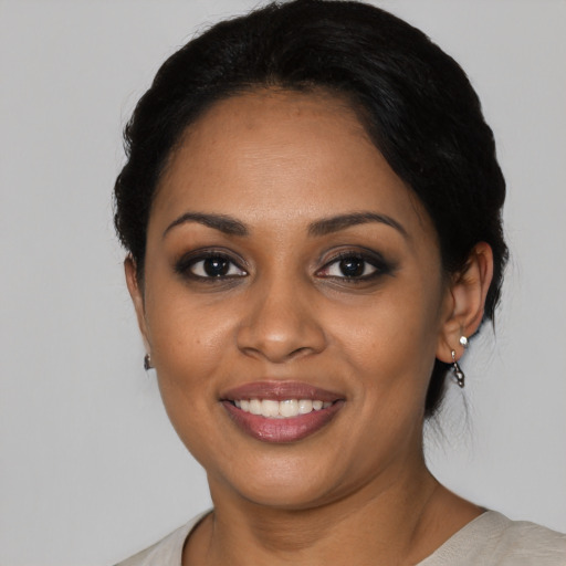Joyful black young-adult female with medium  black hair and brown eyes
