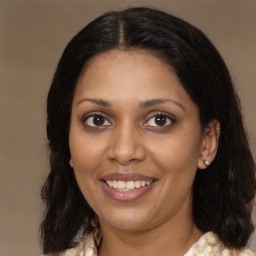 Joyful black young-adult female with medium  brown hair and brown eyes