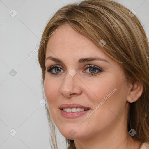 Joyful white young-adult female with long  brown hair and blue eyes