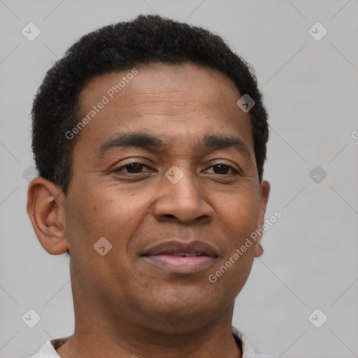 Joyful latino young-adult male with short  brown hair and brown eyes