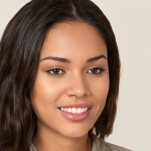 Joyful white young-adult female with long  brown hair and brown eyes