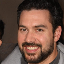 Joyful white adult male with short  black hair and brown eyes