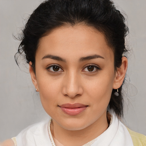 Joyful latino young-adult female with medium  brown hair and brown eyes