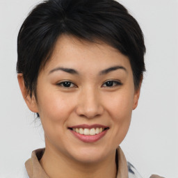 Joyful asian young-adult female with short  brown hair and brown eyes