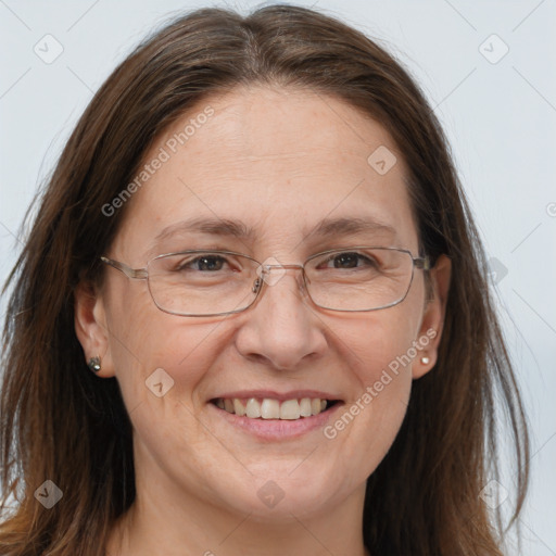 Joyful white adult female with long  brown hair and grey eyes