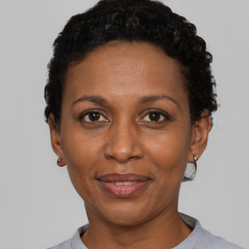 Joyful latino adult female with short  black hair and brown eyes